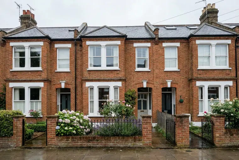 Red-brick Victorian terraced houses with white sash windows